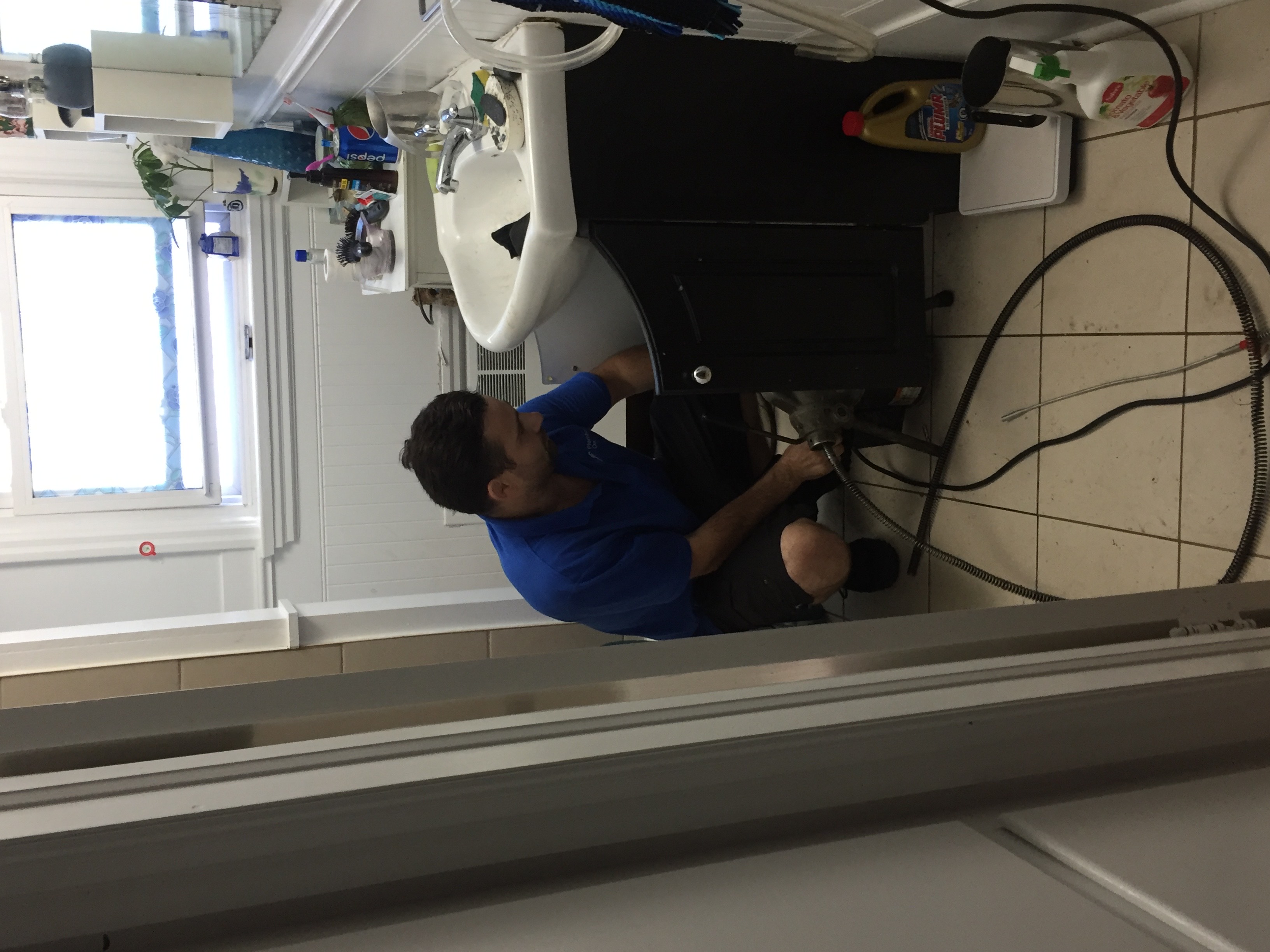 Technician unclogging a sink